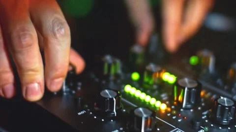 Close Up View Of DJ's Hands Turning Knobs On The Audio Mixing Panel With 動画素材 142047983