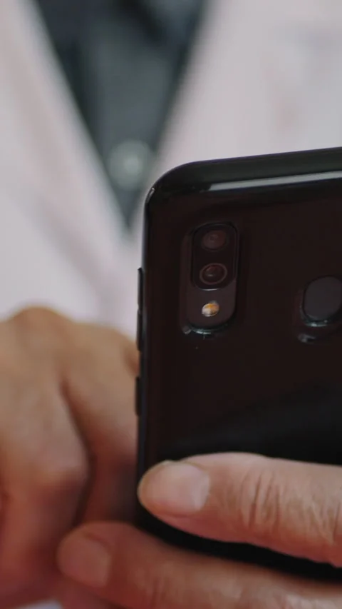 A Close-Up View Of A Doctor Using A Smartphone, Highlighting Professional Health Stock Footage 312981413