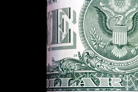 Close-up view of dollar bill. One dollar on black background, macro view. Stock Photos