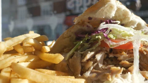 A close up view of doner kebab with bread and chips. Video stock 128940287