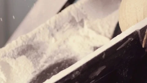 Close up view of dough prepared for baking rolling down, falling down on the Stock Footage 77522444