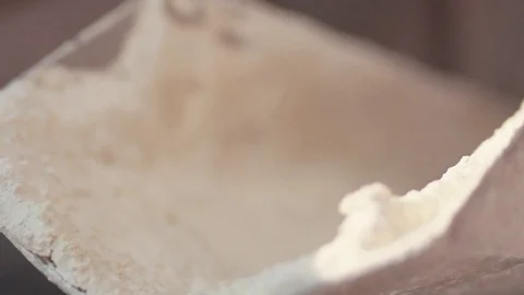 Close up view of dough prepared for baking rolling down, falling down on the Stock Footage 77522618
