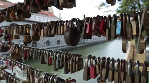A close-up view of dozens of padlocks hanging in a row on a bridge in Slovenia Video stock 304592318