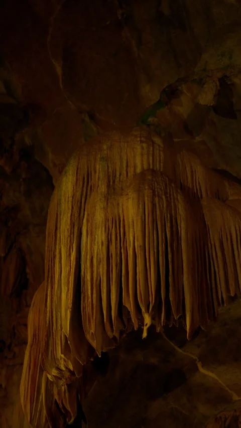 Close-up view of dramatic cave formations with intricate limestone drapes Stock Footage 310487390