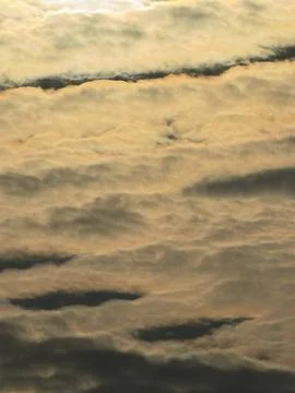 Close-up view of dramatic golden clouds at sunset Stock Photos