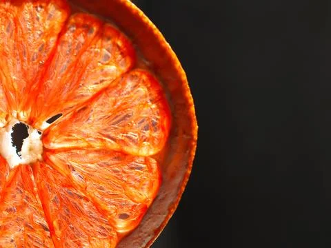Close up view of a dried orange slice on a dark background Stock Photos