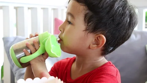 Close up view of drinking child. Thirsty little boy drinking water from bottle. Stock Footage 159522165