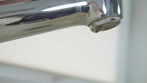 Close-up view of a dripping chrome tap Stock Footage 97073076