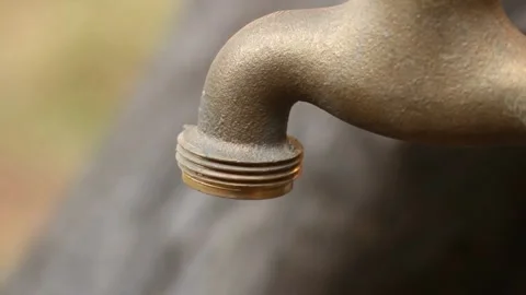 Close-up view of dripping tap symbolizes water wasted drop by drop. Stock Footage 294741170