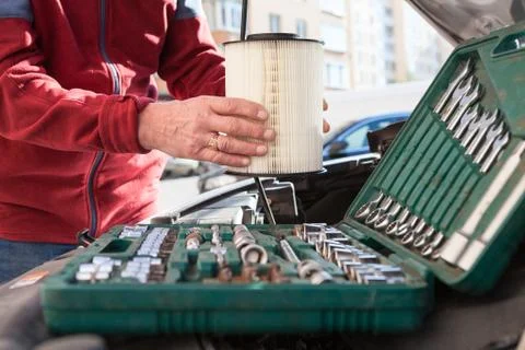 Close up view at driver hands with new clean air filter, replacing without an 스톡 사진