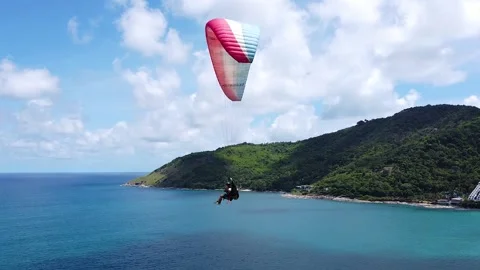 A close view from a drone of a paraglide with two passengers aloft Stock Footage 173720457