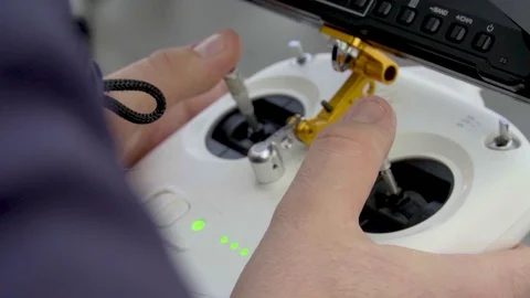 Close up view drone pilot operating professional quadcopter Stock Footage 125203330