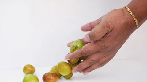 Close view of dropping green fig fruits on a white background Stock-Footage 148214385