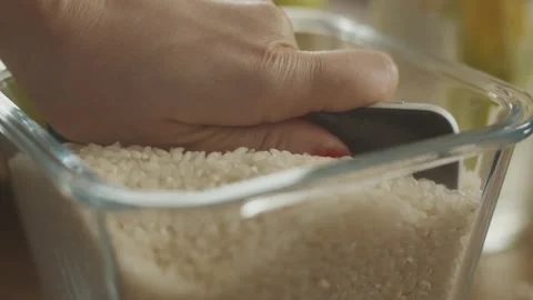 Close view of dropping rice over a bowl filled with white rice Stock Footage 273345789