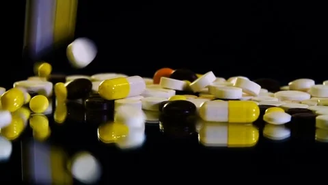 Close-up view of drug tablets and pills falling from above. Stock Footage 81325435