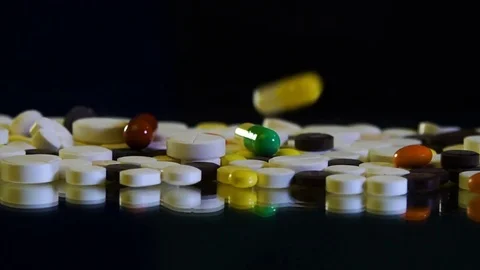 Close-up view of drug tablets and pills falling from above. Stock Footage 81325439
