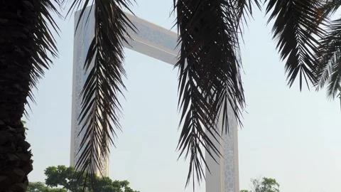 Close Up View of Dubai Frame Framed by Palm Tree Leaves.  Concept of modern.. Stock Footage 347203138