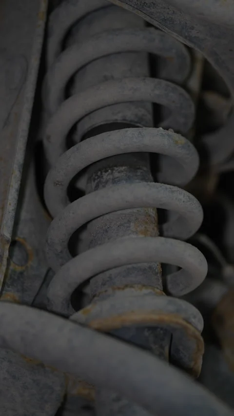 A close-up view of a dusty and rusty car suspension Stock Footage 343552429