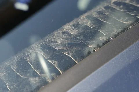 Close-up view of a dusty car window with visible dirt patterns, depicting Stock Photos