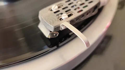 Close up view of dusty needle of old record player with spinning vinyl record Stock Footage 347328770