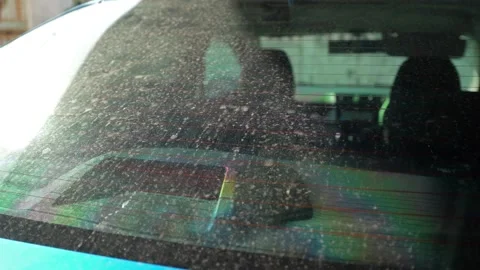 Close-up view of the dusty rear windshield of a blue car. Видео 261920589
