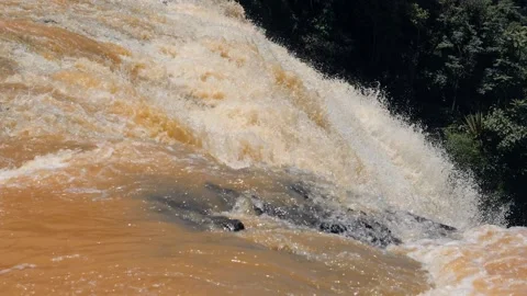 Close up view of dynamic flow of huge waterfall with orange water. Stock Footage 142369087