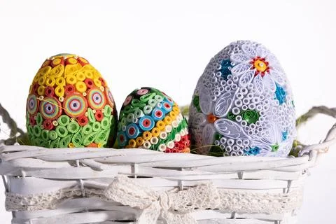 A close-up view of Easter eggs lying in a basket decorated with colorful Stock-Fotos