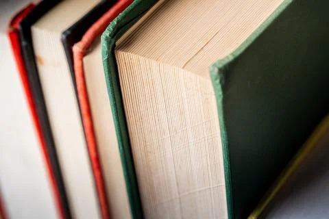 Close-up view of educational books stacked on a table, focusing on the textured Stock Photos