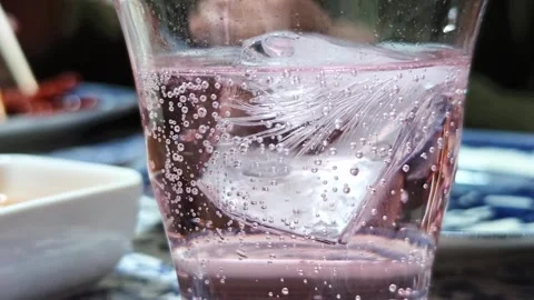 Close-up view of effervescence from a glass of Pink Lemonade Stock Footage 341801747