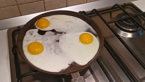 Close Up View of Eggs Cooking in a Pan Stock Footage 144608721