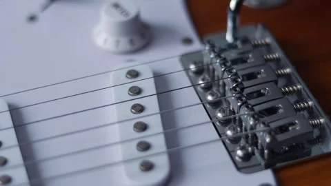 Close-up view of electric guitar strings and bridge, highlighting intricate Stock Footage 339191329
