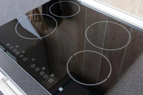 Close up view of an electrical kitchen induction ceramic hob with kitchen f.. Stock Photos