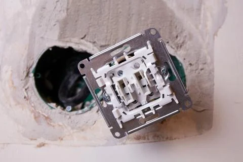 A close-up view of an electrical outlet being installed into a wall. Stock Photos