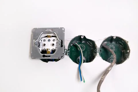 A close-up view of an electrical outlet being installed into a wall. Stock Photos