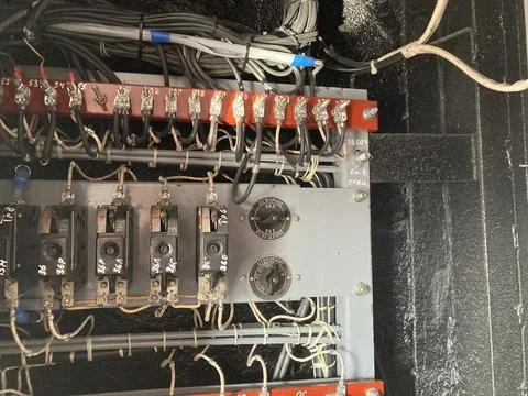 Close-up view of an electrical panel filled with components, switches, butt.. Stock Photos