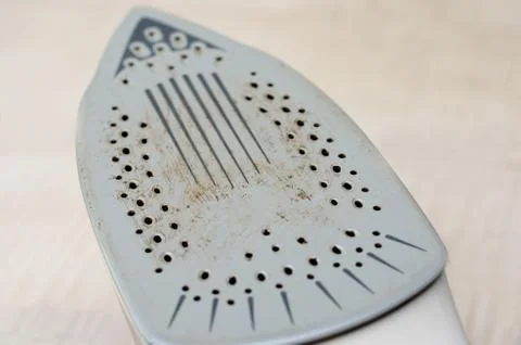 Close-up  view of  electrical   rusty   old clothes iron back  full of dirt a Stock Photos