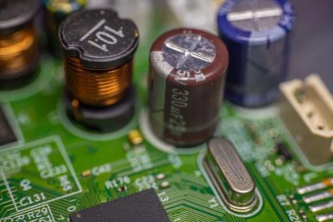 Close-up view of electronic circuit board components including capacitors, .. Stock Photos