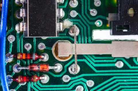 Close-up view of electronic components on a green circuit board with resist.. Stock Photos