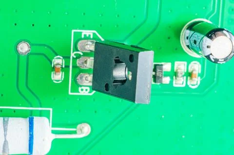 Close-up view of electronic components on a green circuit board with intric.. Stock Photos