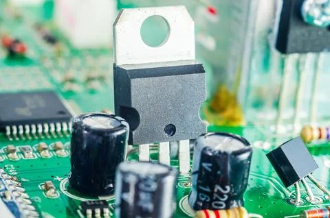 Close-up view of electronic components on a green circuit board, highlighti.. Stock Photos