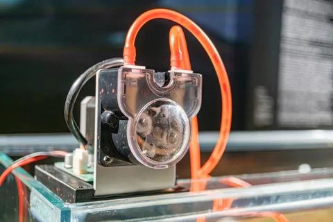 Close-up view of an electronic device, with an orange power cord and a circ.. Stock Photos