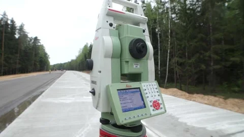 Close-up view of electronic level or theodolite at edge of road Stock Footage 158051066