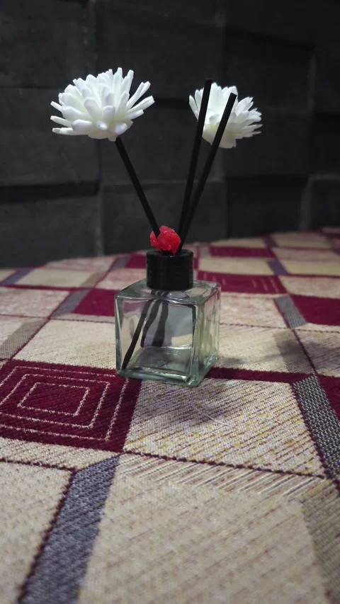 A close-up view of an elegant reed diffuser serving as a room freshener. The cle Vídeos de archivo 332474161