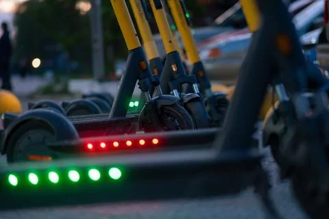 Close up view of elements of electric scooters parked on the street Stock Photos
