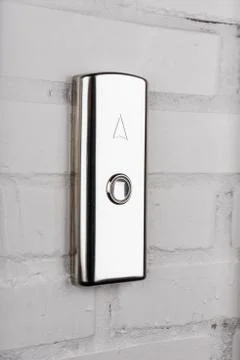 Close up view of elevator button up direction on white wall Foto stock