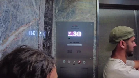 Close up view elevator control panel with floor indicator and tourists standing 스톡 동영상 328233145