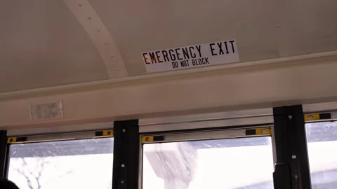 Close up view of emergency exit sign inside a school bus. Safety warning label Video stock 330987152