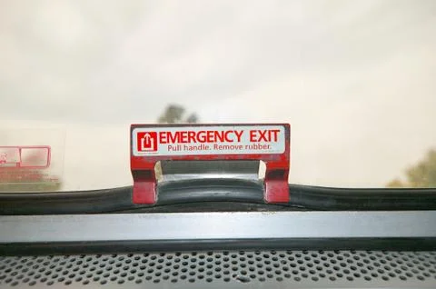 Close up view of an emergency exit sign and latch Stock Photos