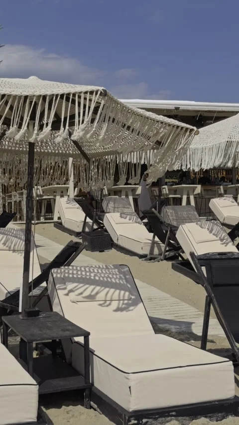 Close View Of Empty Beach Loungers Under Fringed Shade In Chalkidiki Greece Stock Footage 344371851