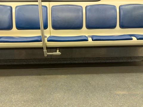 Close up view of empty blue plastic seats inside subway train carriage, symbo Stock Photos